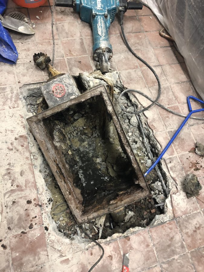 Commercial grease trap repair in progress at a restaurant kitchen in Orange County
