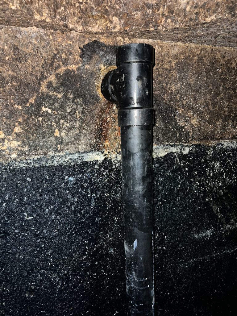 Damaged grease trap baffle T showing internal failure in interceptor system