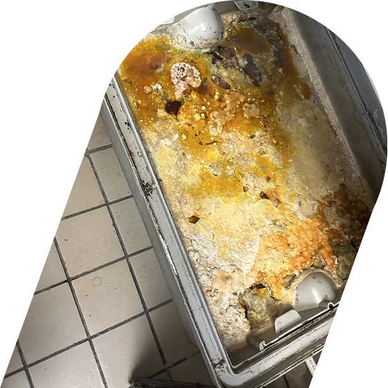 Full commercial grease trap filled with fats, oils, and grease buildup in a restaurant kitchen in Tustin
