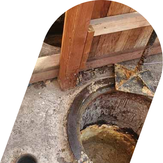Open grease trap in a Huntington Beach restaurant showing grease buildup, highlighting the need for professional cleaning and maintenance.