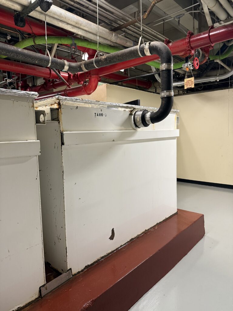 Hydromechanical underground grease interceptor with damaged baffle needing emergency grease interceptor repair in a commercial kitchen